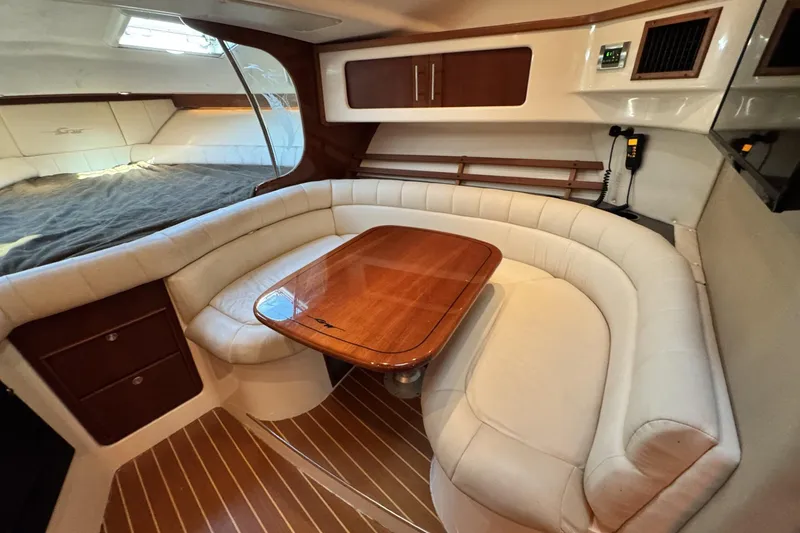 Slide: The Image of Luxurious 2008 Grady-White Express 360 cabin with plush seating and elegant wood table. - 56