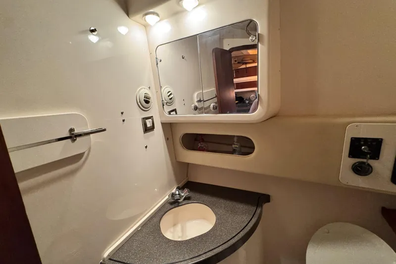 Slide: The Image of 2008 Grady-White Express 360 boat bathroom with sink, mirror, and storage. - 59