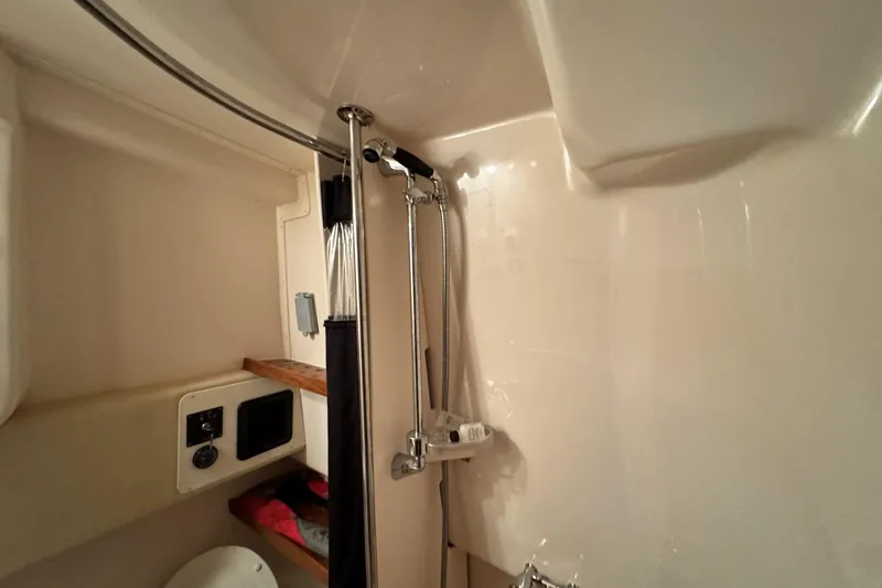 Slide: The Image of 2008 Grady-White Express 360 bathroom with shower and storage shelves. - 60