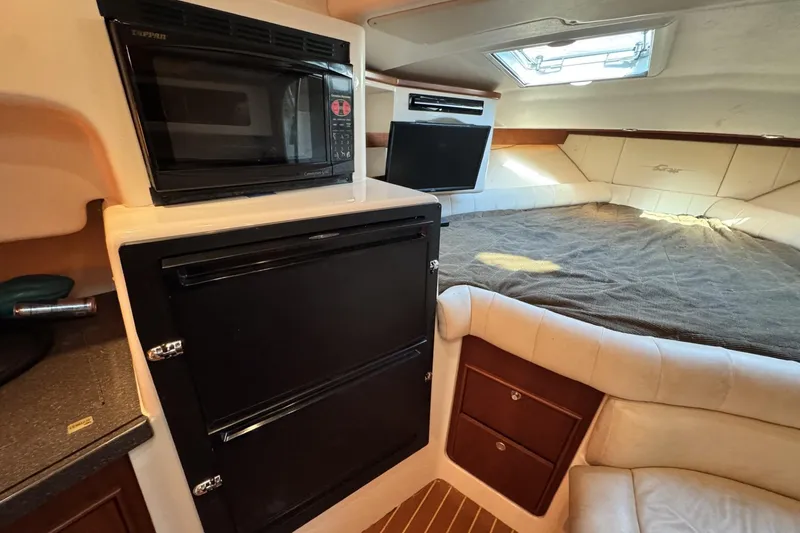Slide: The Image of 2008 Grady-White Express 360 cabin interior with microwave, fridge, and cozy bed. - 61