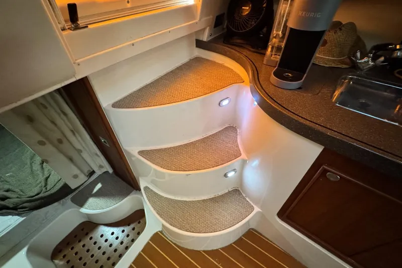 Slide: The Image of Interior of 2008 Grady-White Express 360 with illuminated steps and kitchenette. - 63