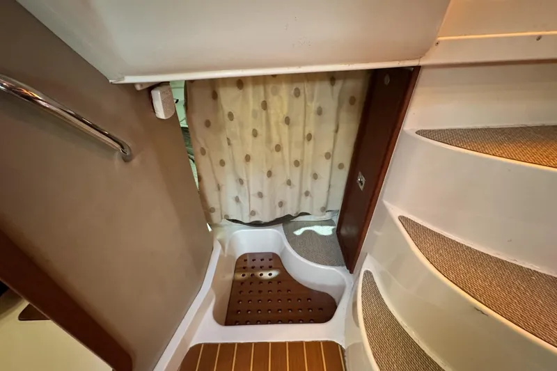 Slide: The Image of 2008 Grady-White Express 360 interior with stairs and polka dot curtain. - 64