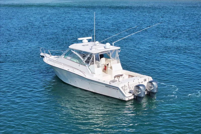 Slide: The Image of 2008 Grady-White Express 360 boat on clear blue water, featuring twin Yamaha engines. - 7