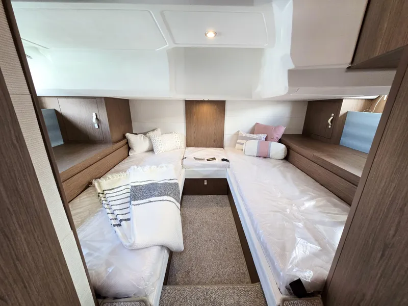 Slide: The Image of 2019 Beneteau Gran Turismo 40 cabin interior with twin beds and cozy decor. - 10