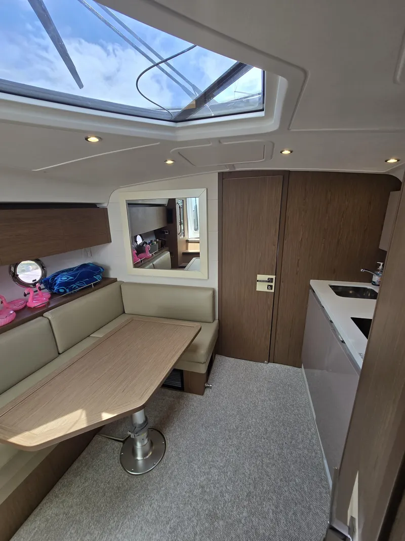 Slide: The Image of Interior of 2019 Beneteau Gran Turismo 40 yacht with skylight, seating, and kitchenette. - 15