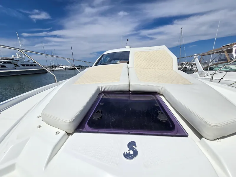 Slide: The Image of 2019 Beneteau Gran Turismo 40 yacht with sunbathing deck, docked in a marina under blue skies. - 19