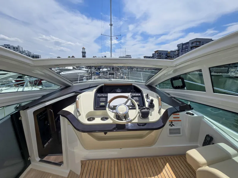 Slide: The Image of Helm of 2019 Beneteau Gran Turismo 40 yacht with modern controls and panoramic view. - 3