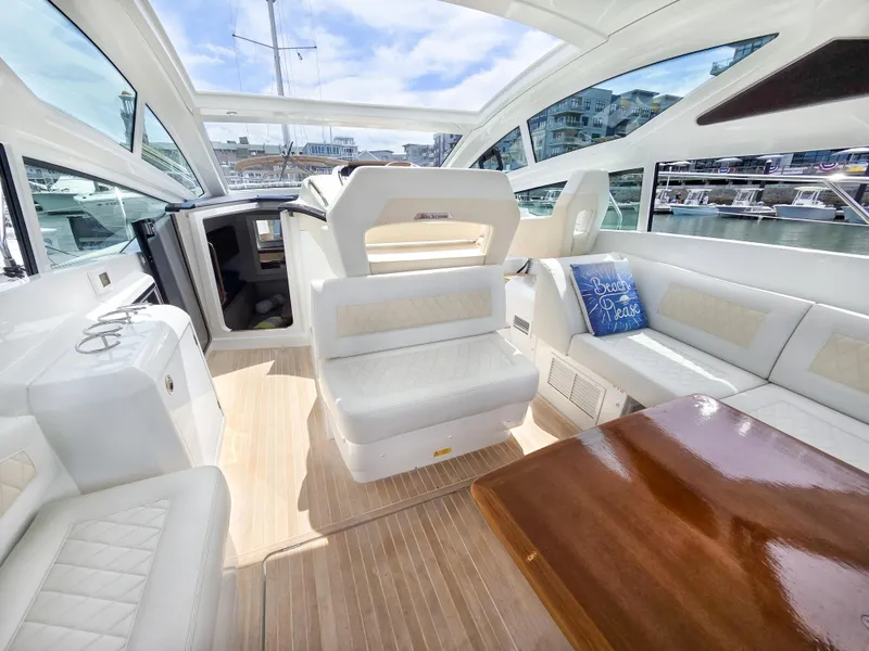 Slide: The Image of Luxurious interior of 2019 Beneteau Gran Turismo 40 yacht with elegant seating and wooden table. - 8