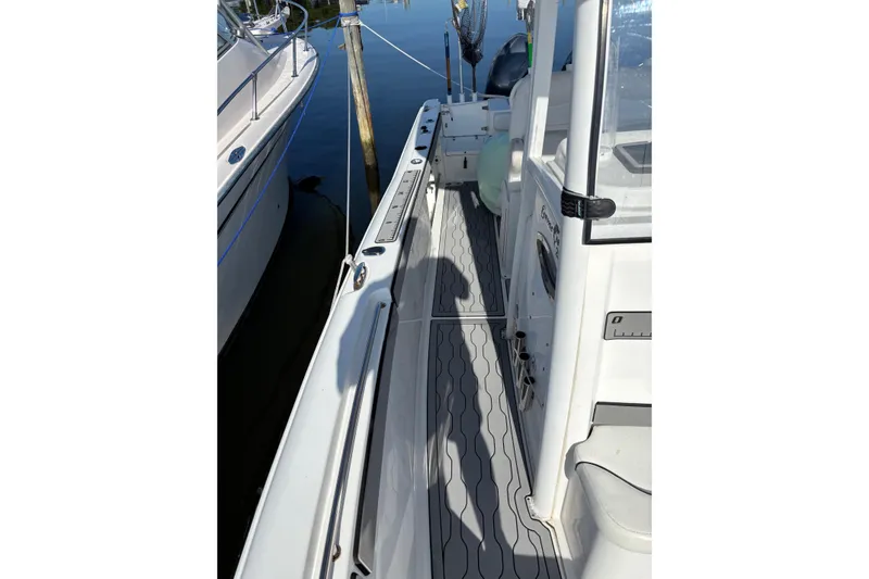 Slide: The Image of 2013 Sea Hunt Gamefish 25 boat deck with sleek design and fishing equipment. - 3