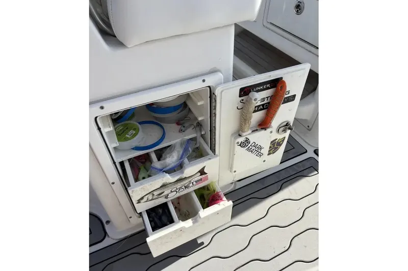 Slide: The Image of 2013 Sea Hunt Gamefish 25 fishing tackle storage with open drawers and tools. - 6