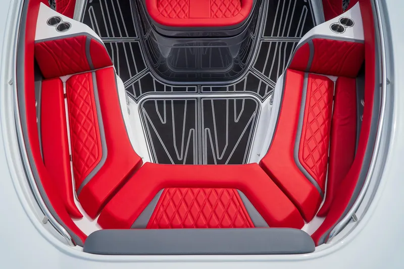Slide: The Image of Luxurious red seating in 2024 MTI V42 boat interior, featuring sleek design and cup holders. - 12