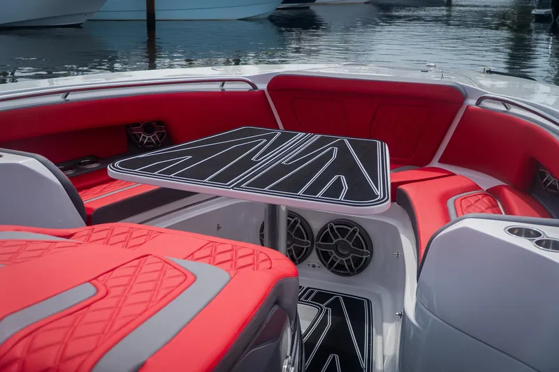 Slide: The Image of Luxurious 2024 MTI V42 boat interior with red seating and sleek black table design. - 13