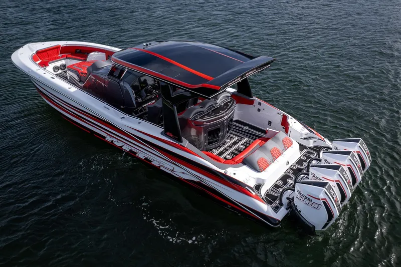 Slide: The Image of 2024 MTI V42 boat with sleek design and powerful engines on open water. - 2