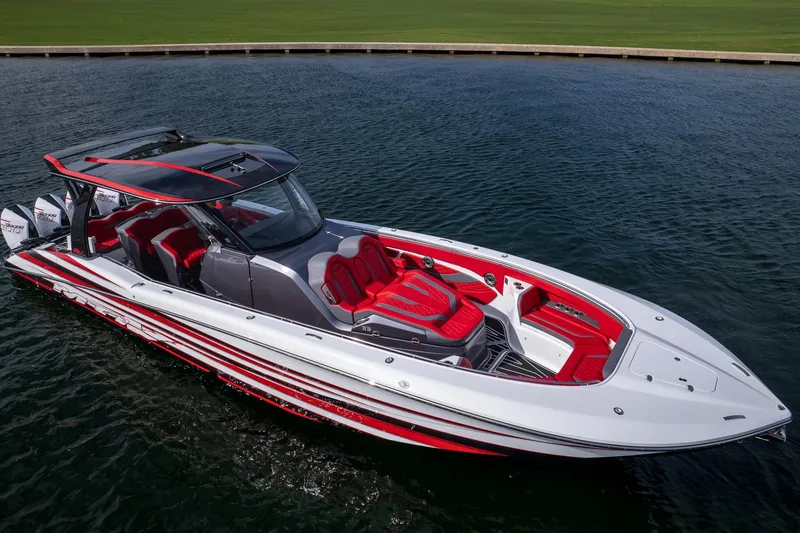 Slide: The Image of 2024 MTI V42 boat with sleek design, red and white accents, on calm water. - 3
