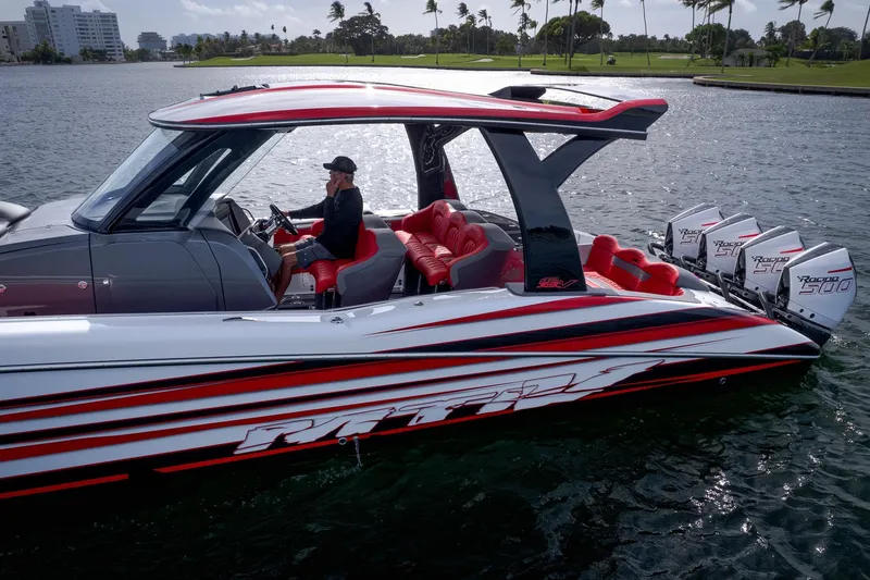 Slide: The Image of 2024 MTI V42 boat with red accents and multiple outboard engines on the water. - 6