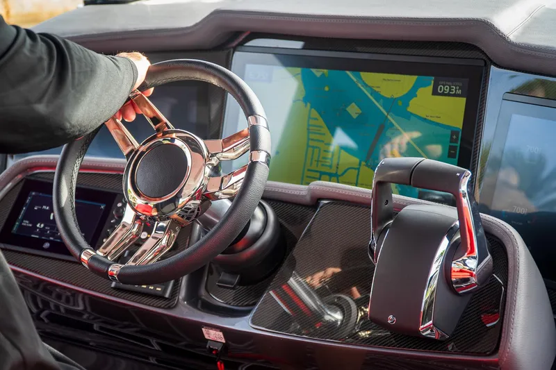 Slide: The Image of Steering wheel and navigation display of 2024 MTI V42 boat cockpit. - 7