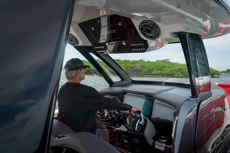 Slide: The Image of Man piloting 2024 MTI V42 boat with advanced dashboard technology. - 8