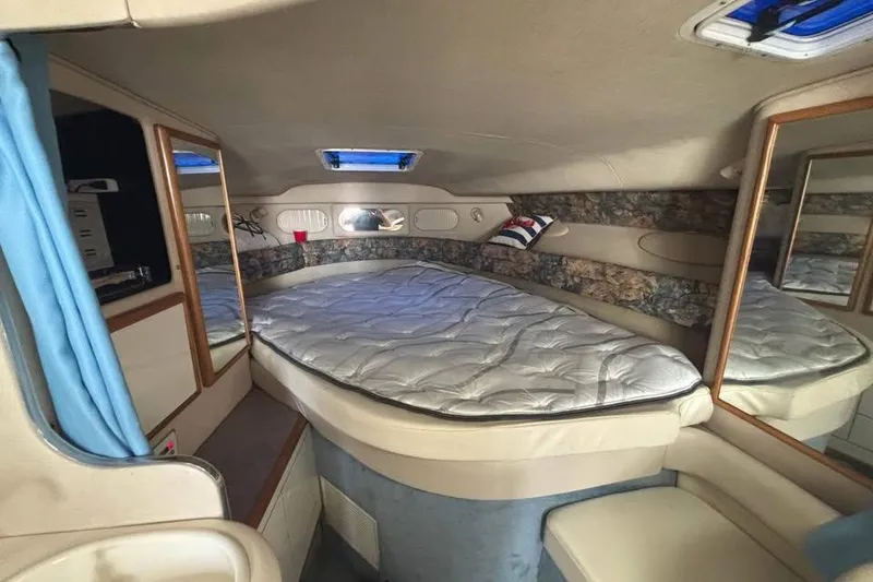 Slide: The Image of Interior cabin of 1996 Sea Ray 330 Sundancer with bed and mirrors. - 10