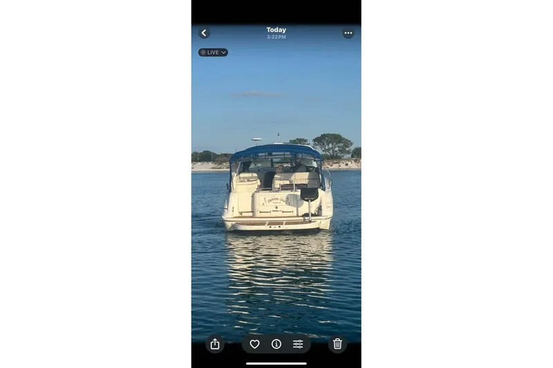 Slide: The Image of 1996 Sea Ray 330 Sundancer yacht on calm water with blue canopy. - 2