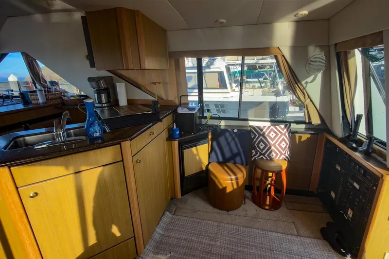 Slide: The Image of Interior of 2002 Bayliner 3988 Command Bridge Motoryacht with kitchen and seating area. - 17