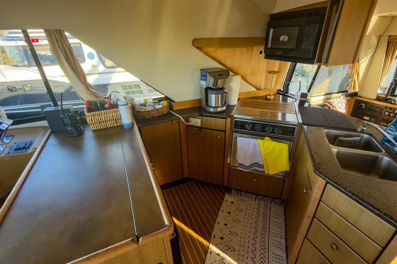 Slide: The Image of Interior of 2002 Bayliner 3988 Command Bridge Motoryacht kitchen with appliances and wooden cabinetry. - 20