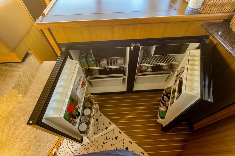Slide: The Image of 2002 Bayliner 3988 Command Bridge Motoryacht kitchen with open double-door refrigerator. - 21
