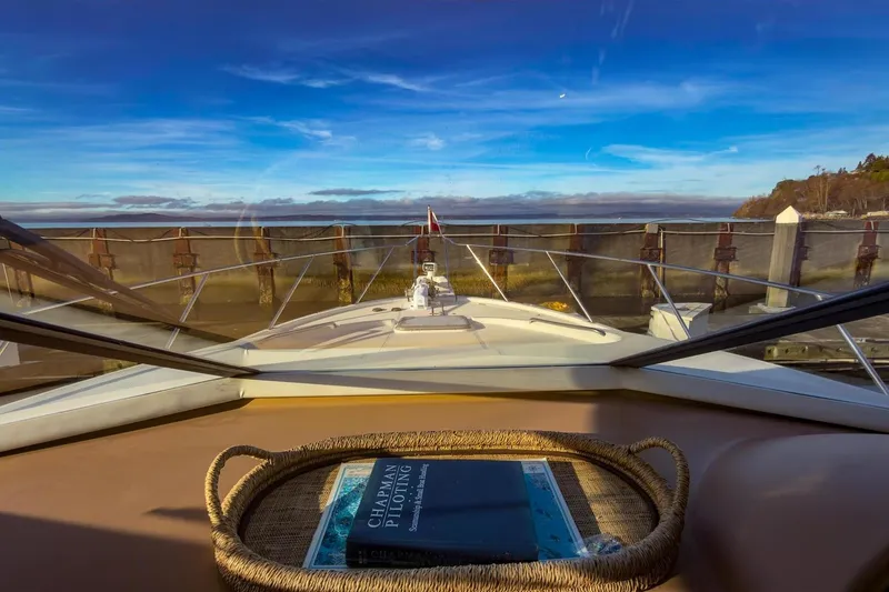 Slide: The Image of 2002 Bayliner 3988 Command Bridge Motoryacht view from helm, docked with clear blue sky. - 25