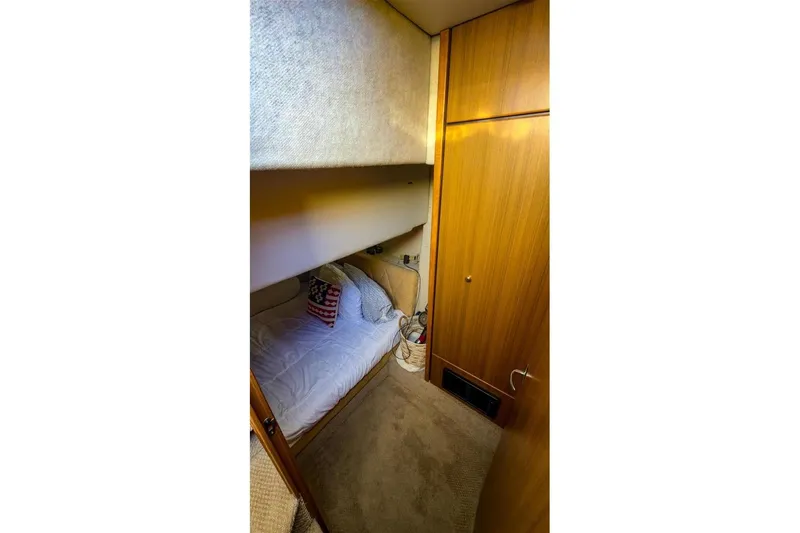Slide: The Image of Cozy cabin interior of 2002 Bayliner 3988 Command Bridge Motoryacht with wooden paneling. - 26