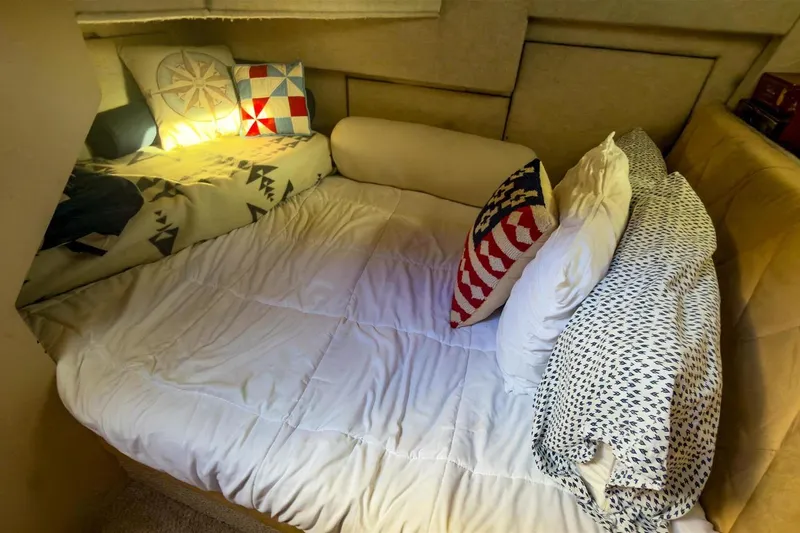 Slide: The Image of Cozy cabin interior of 2002 Bayliner 3988 Command Bridge Motoryacht with nautical-themed bedding. - 27