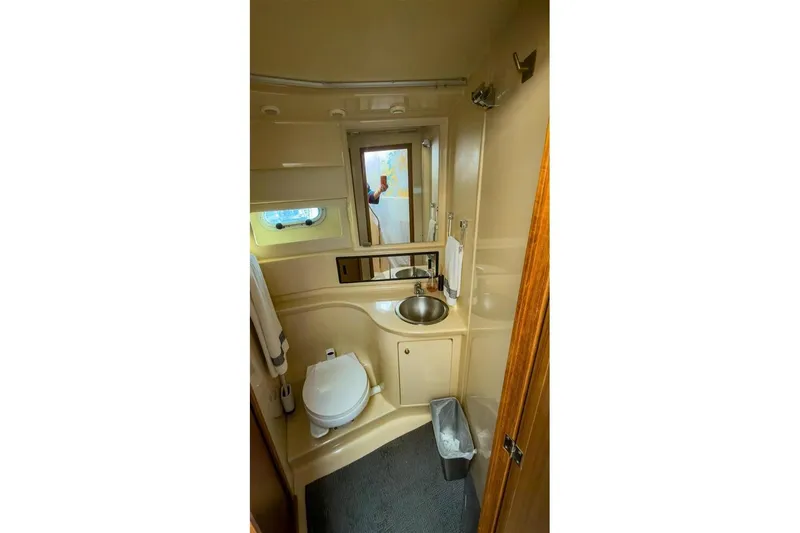 Slide: The Image of 2002 Bayliner 3988 Command Bridge Motoryacht bathroom with sink, toilet, and mirror. - 28