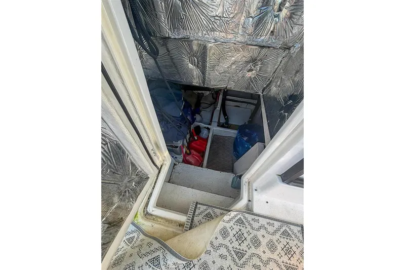 Slide: The Image of Engine room access on 2002 Bayliner 3988 Command Bridge Motoryacht, featuring insulation and storage. - 36