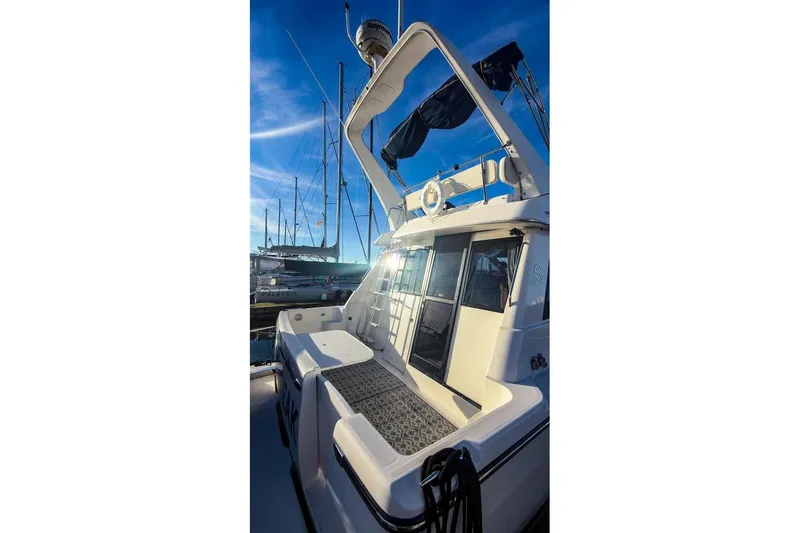 Slide: The Image of 2002 Bayliner 3988 Command Bridge Motoryacht docked under clear blue sky. - 6
