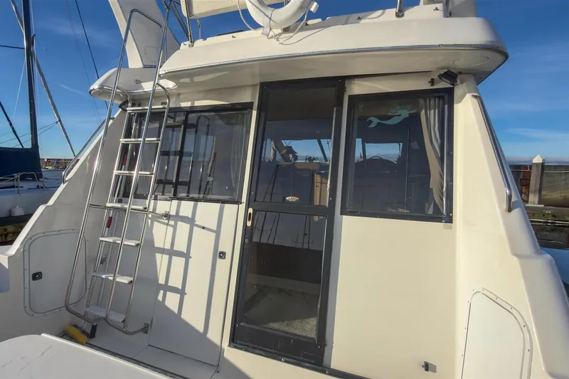 Slide: The Image of 2002 Bayliner 3988 Command Bridge Motoryacht with ladder and sliding glass door. - 7