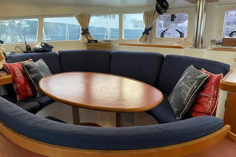 Slide: The Image of Interior of 2006 Lagoon 410-S2 yacht with cozy seating and nautical-themed cushions. - 12