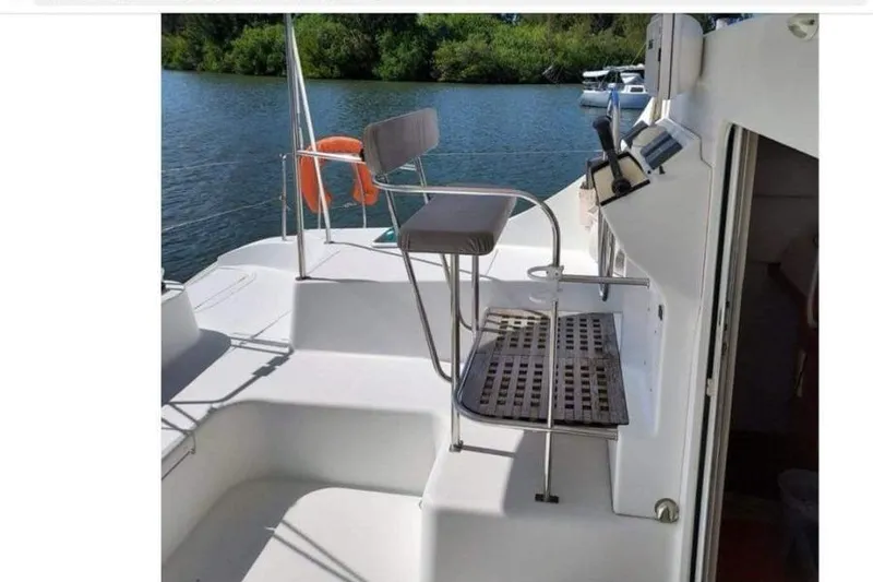 Slide: The Image of 2006 Lagoon 410-S2 yacht deck with seating and water view. - 2