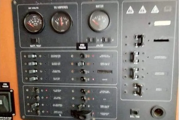 Slide: The Image of Control panel of a 2006 Lagoon 410-S2 catamaran with gauges and switches. - 21