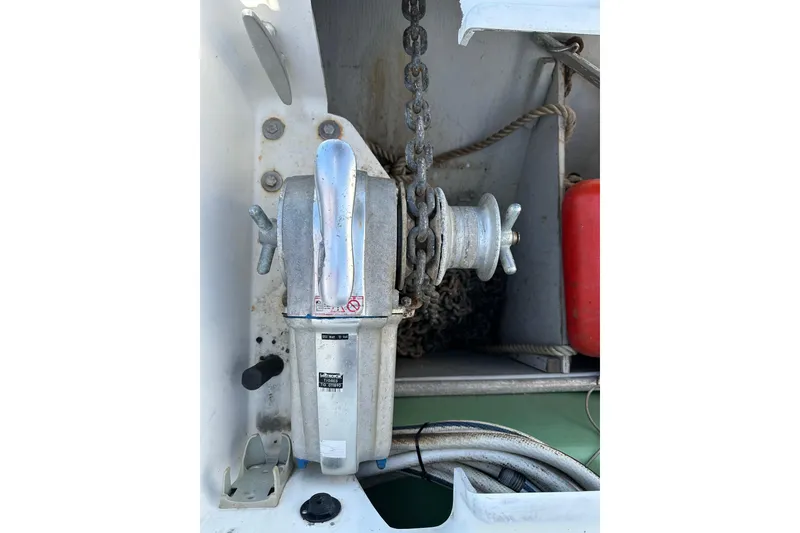 Slide: The Image of Anchor winch on 2006 Lagoon 410-S2 catamaran, featuring chain and rope storage. - 25