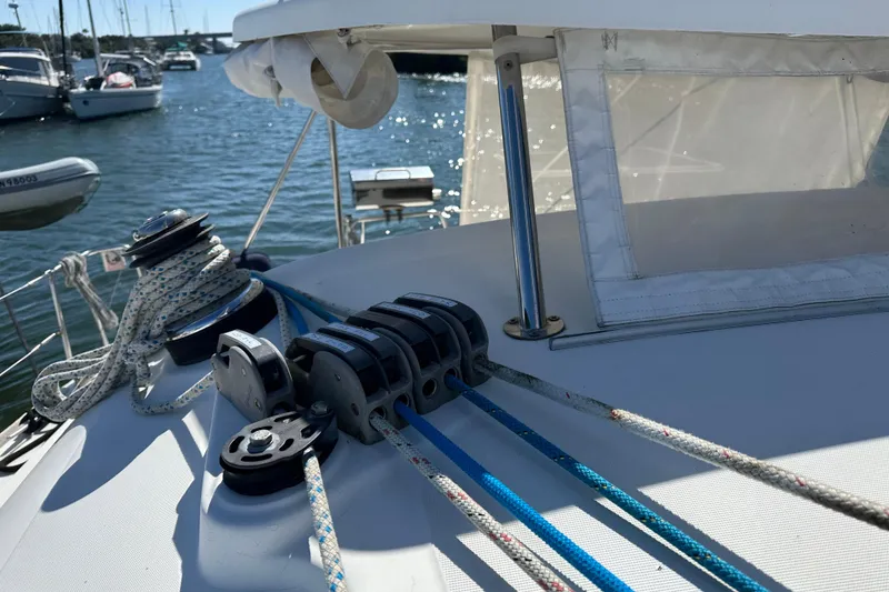 Slide: The Image of Close-up of 2006 Lagoon 410-S2 sailboat deck with ropes and winch in marina. - 27