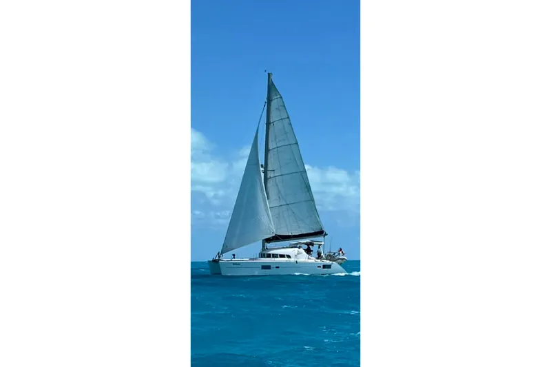 Slide: The Image of 2006 Lagoon 410-S2 catamaran sailing on clear blue ocean waters. - 3