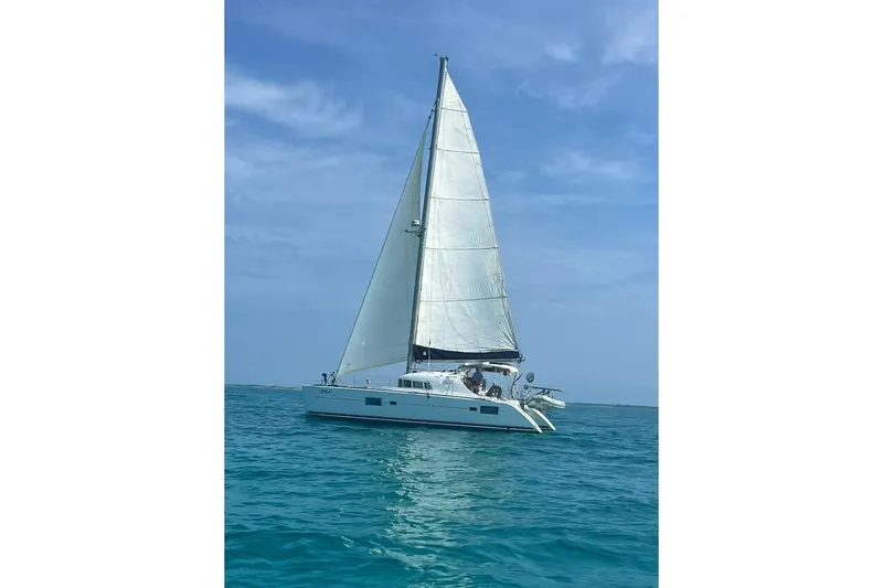 Slide: The Image of 2006 Lagoon 410-S2 catamaran sailing on clear blue ocean under a sunny sky. - 33