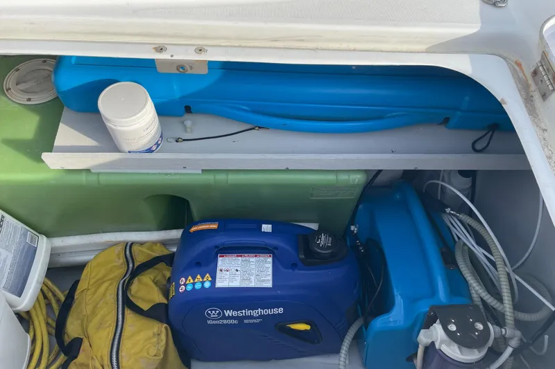 Slide: The Image of Storage compartment of a 2006 Lagoon 410-S2 with Westinghouse generator and supplies. - 34
