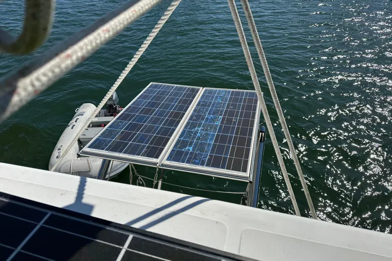 Slide: The Image of Solar panels on a 2006 Lagoon 410-S2 catamaran, reflecting sunlight on the water. - 36
