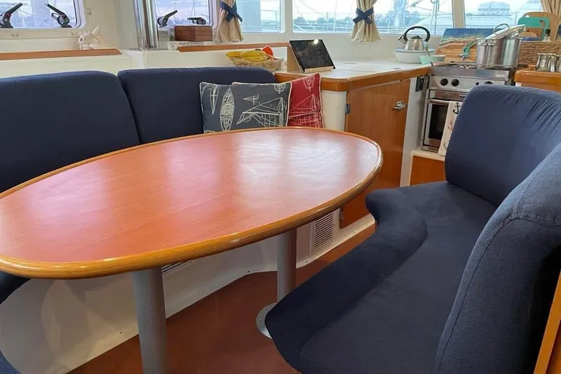 Slide: The Image of Interior of 2006 Lagoon 410-S2 yacht with dining area and kitchen. - 4
