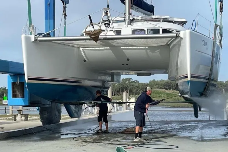 Slide: The Image of 2006 Lagoon 410-S2 catamaran being cleaned at a boatyard. - 40