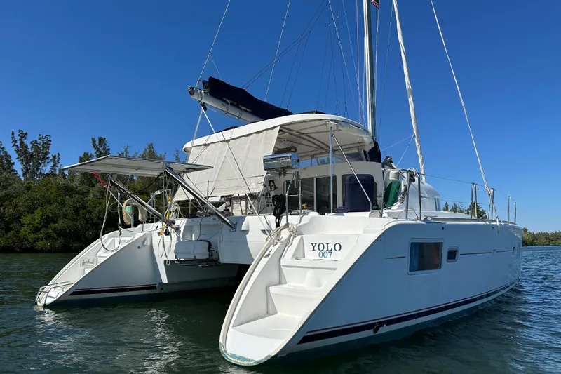 Slide: The Image of 2006 Lagoon 410-S2 catamaran on water, clear sky, rear view. - 41