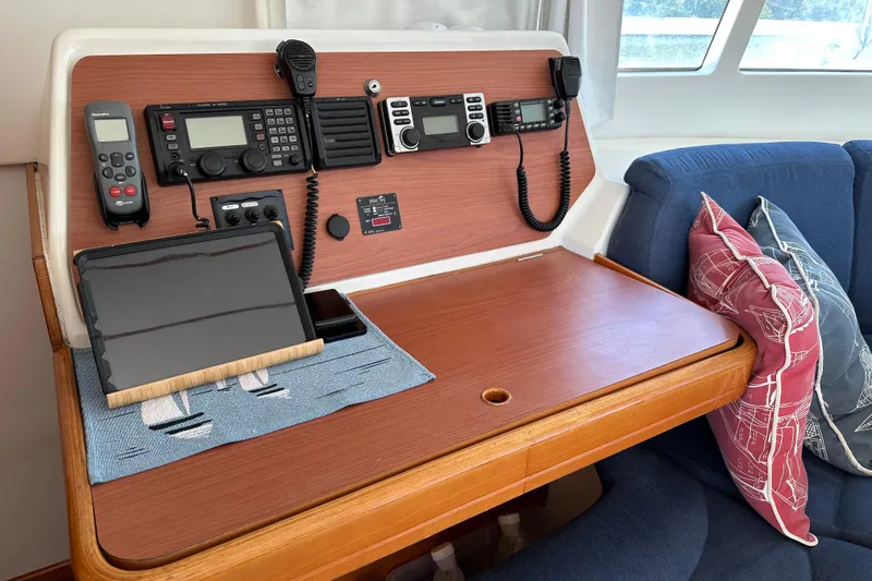Slide: The Image of Navigation station in a 2006 Lagoon 410-S2 catamaran with communication equipment and tablet. - 10