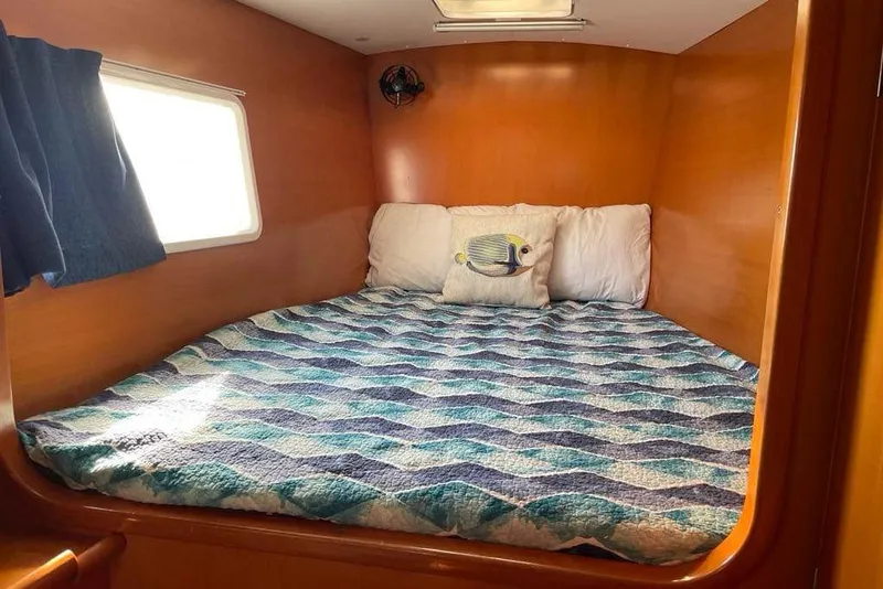 Slide: The Image of Cozy cabin bed in 2006 Lagoon 410-S2 catamaran with nautical-themed bedding. - 15