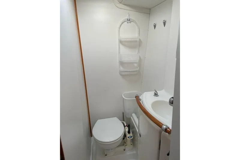 Slide: The Image of Compact bathroom in 2006 Lagoon 410-S2 yacht with toilet and sink. - 17