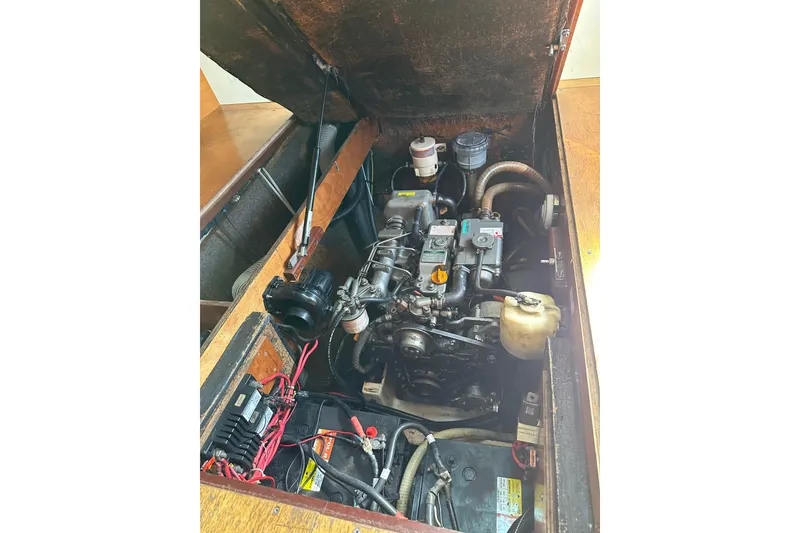 Slide: The Image of Engine compartment of a 2006 Lagoon 410-S2 catamaran, showcasing mechanical components. - 37