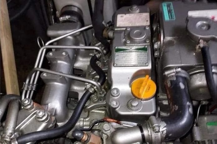 Slide: The Image of Engine compartment of a 2006 Lagoon 410-S2 catamaran, showing mechanical components and hoses. - 38